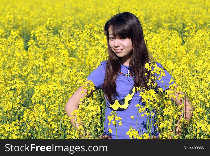 Smiling beauty teenage girl on background with yellow field. Smiling beauty teenage girl on background with yellow field