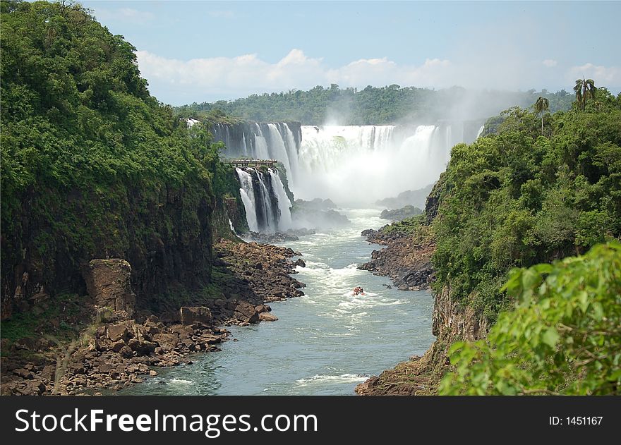 Devil´s throat at world largest Waterfalls Falls in Iguazu on a bright sunny day. Devil´s throat at world largest Waterfalls Falls in Iguazu on a bright sunny day