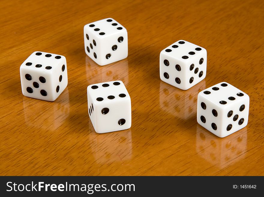 Five dices on a table