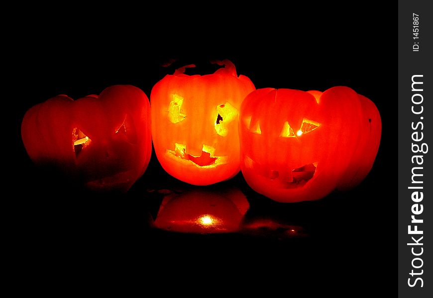 3 red burning pumpkins with fearful faces & fire eyes. 3 red burning pumpkins with fearful faces & fire eyes