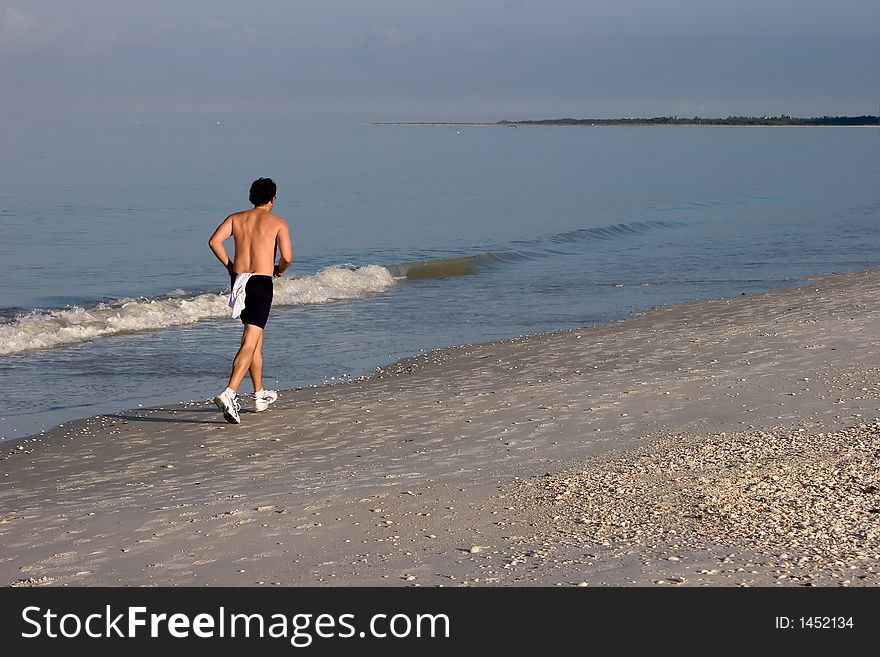 Man Jogging on the Beach
