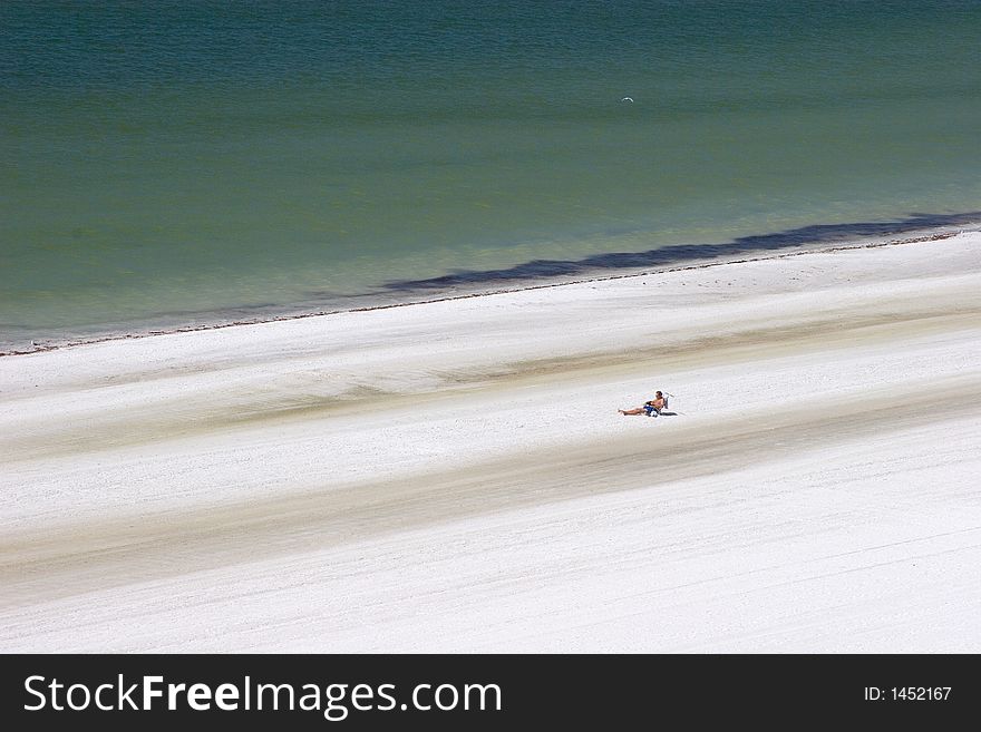 Man Sunning on the Beach Alone