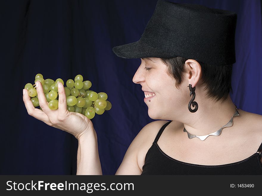 Thirty something model eating green grapes. Thirty something model eating green grapes