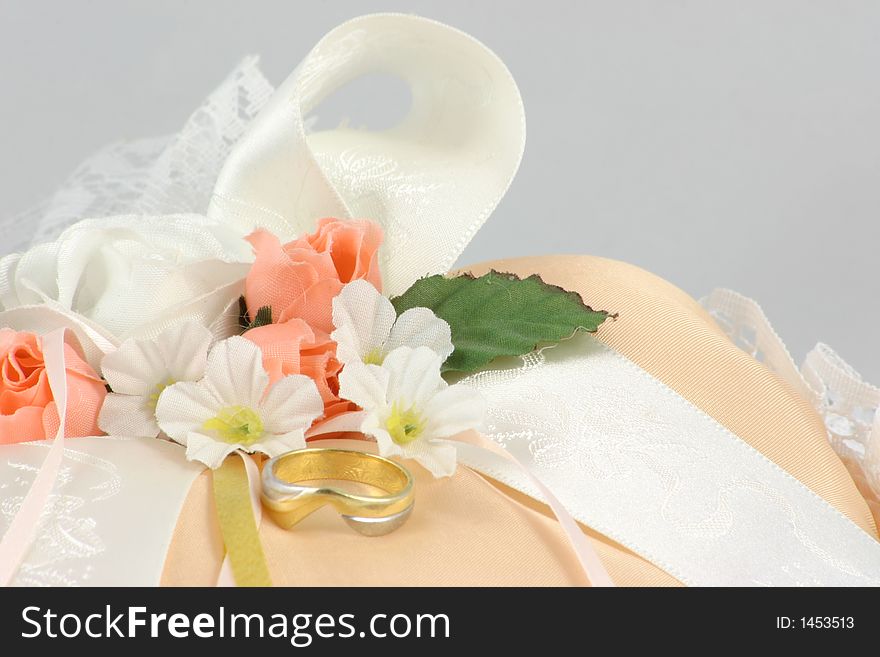 Wedding ring on a cushion with flowers and ribbons. Wedding ring on a cushion with flowers and ribbons