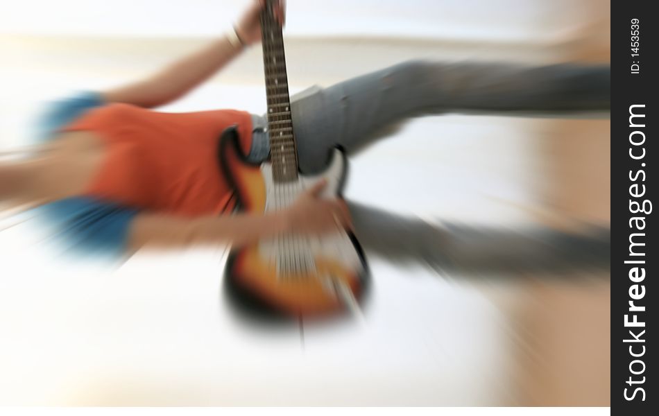 Female guitarist playing electric guitar with radial blurr