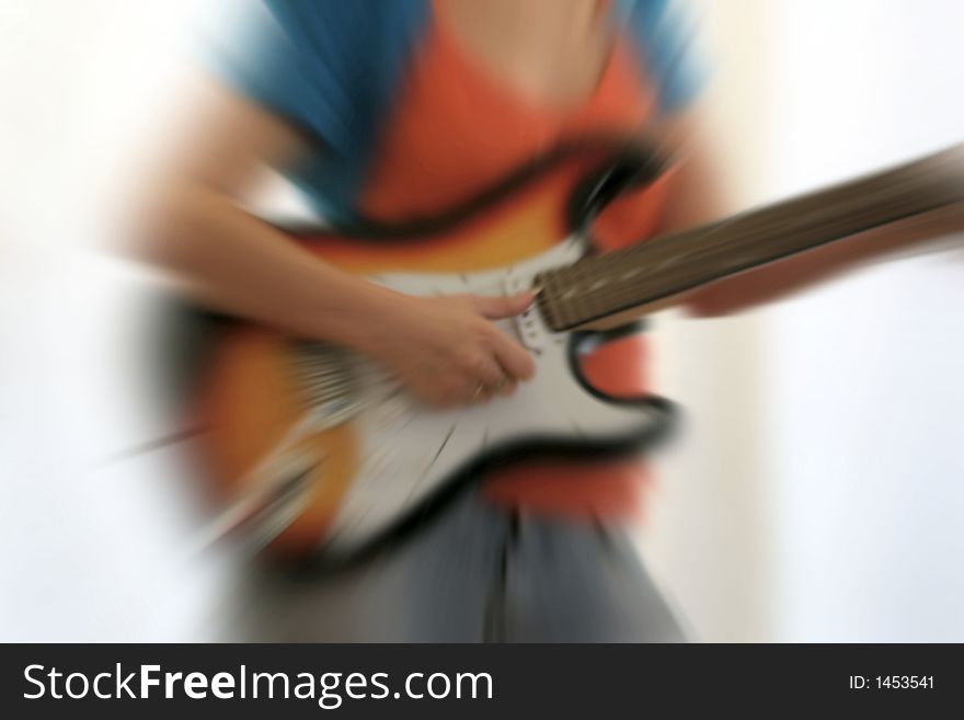 Female guitarist playing electric guitar with radial blurr