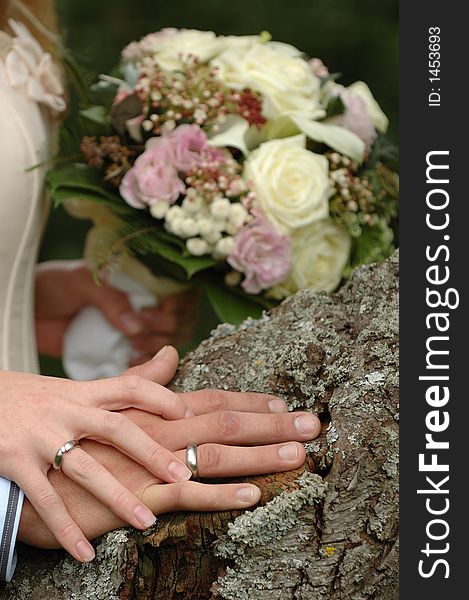 Hands, rings and bouquet