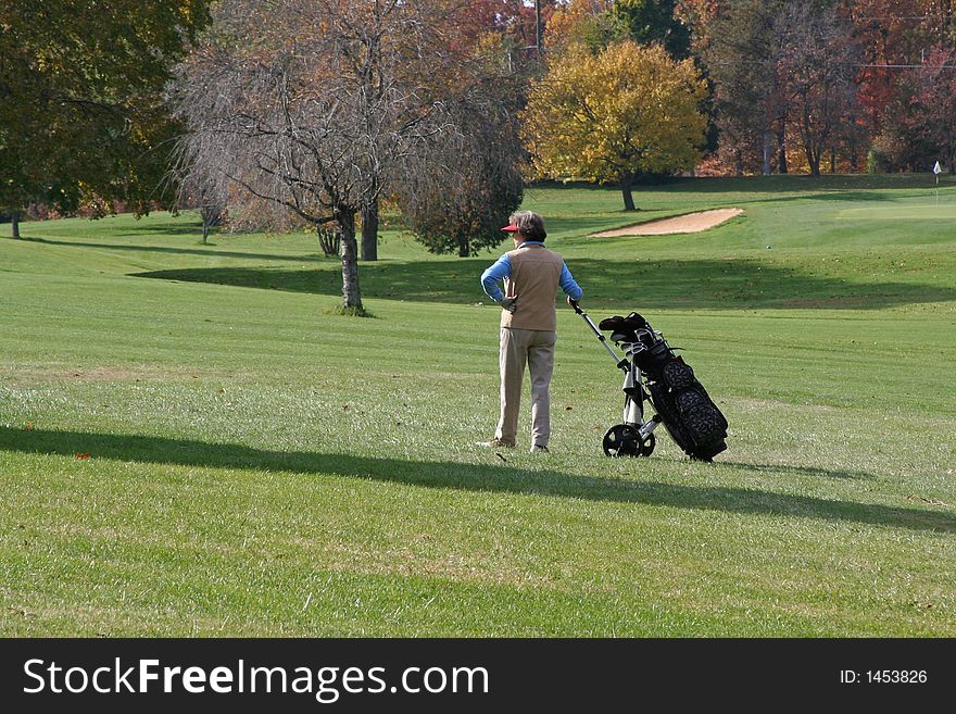 A lady golfer surveys the course