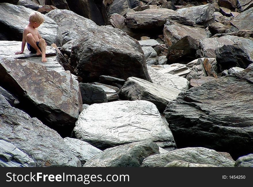 An image of a Boy on the Rocks, taken in Cornwall, England in summer 2003