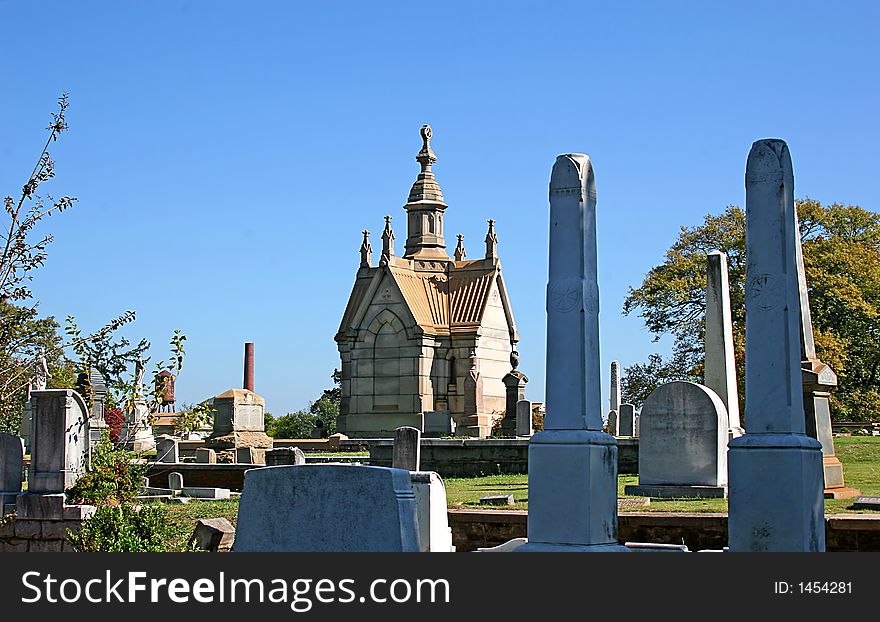 Mausoleum and crypt with headstones in old graveyard