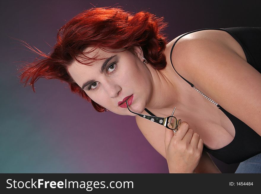 Beautiful girl with red hair in front of colored background in windy area. Beautiful girl with red hair in front of colored background in windy area