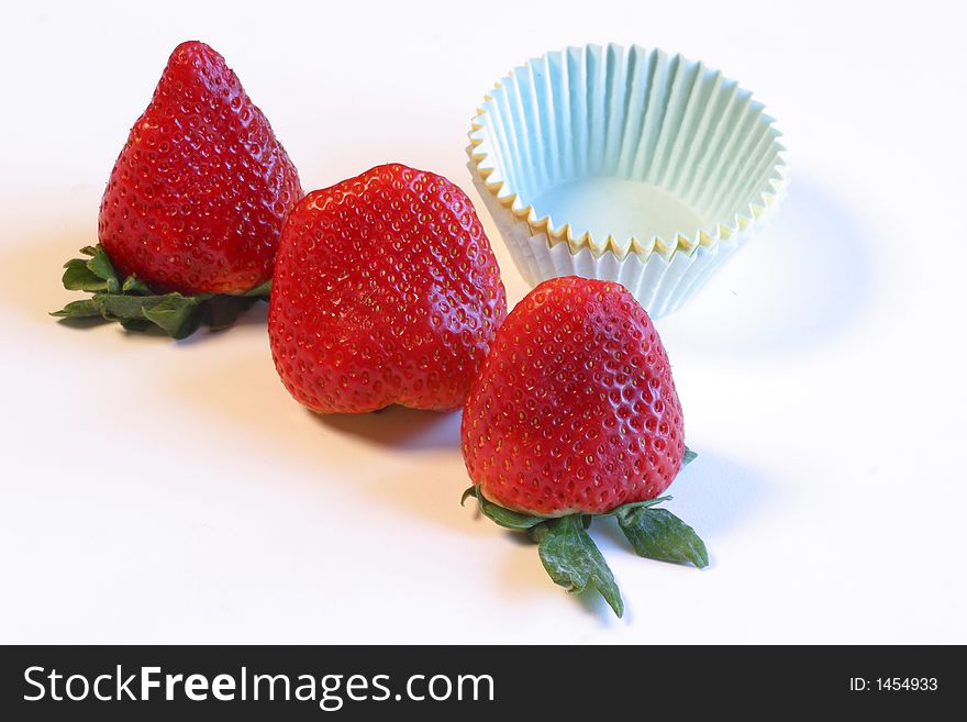 Three whole red ripe  strawberries. stack of pastel paper cupcake holders
An image shot on a white background with studio lights.
Heathy eating, treat, freshness,beginnings,
food & beverage
lifestyles. Three whole red ripe  strawberries. stack of pastel paper cupcake holders
An image shot on a white background with studio lights.
Heathy eating, treat, freshness,beginnings,
food & beverage
lifestyles