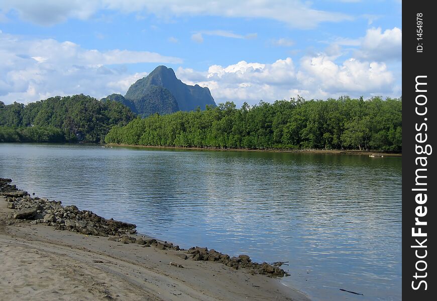 Approaching Thailand's Phang Nga Bay by the river's edge