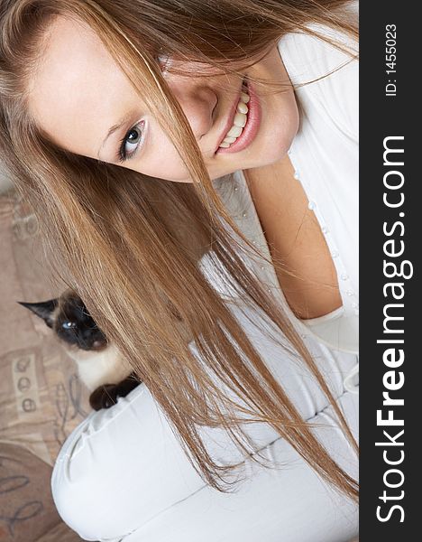 Young happy girl in white with cat