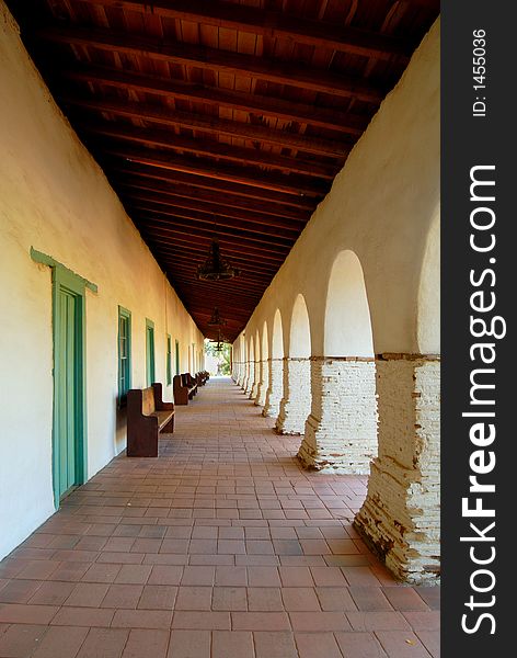 A series of arches along the main walkway of the San Juan Bautista Mission