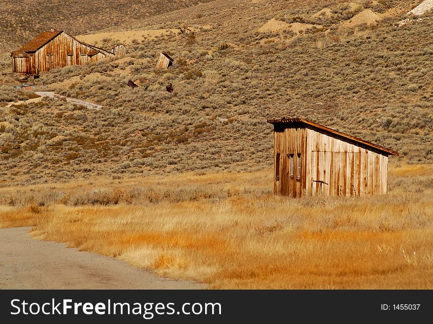 Two deserted wooden structures in old mining town