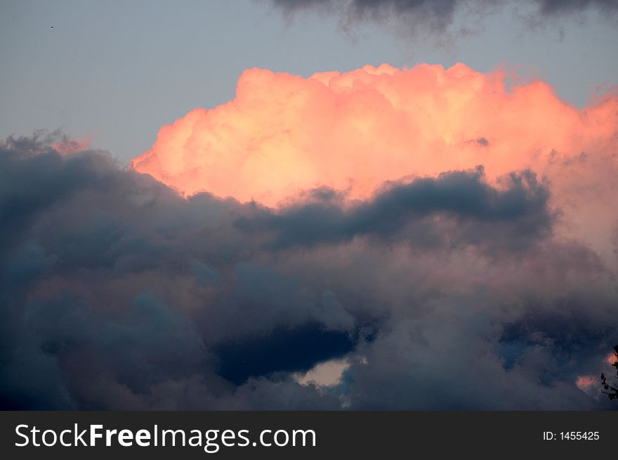 Clouds with orange color and blue sky