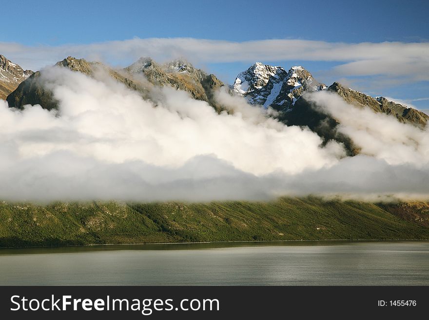 Cloudy mountain with snow on top and lake at New Zealand. Cloudy mountain with snow on top and lake at New Zealand