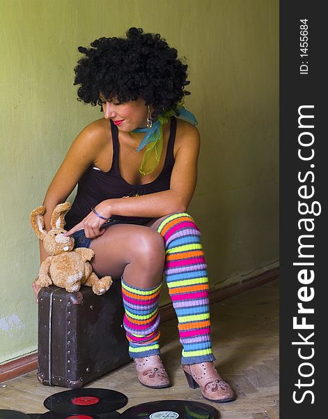 Cute curly disco girl with rabbits and suitecase