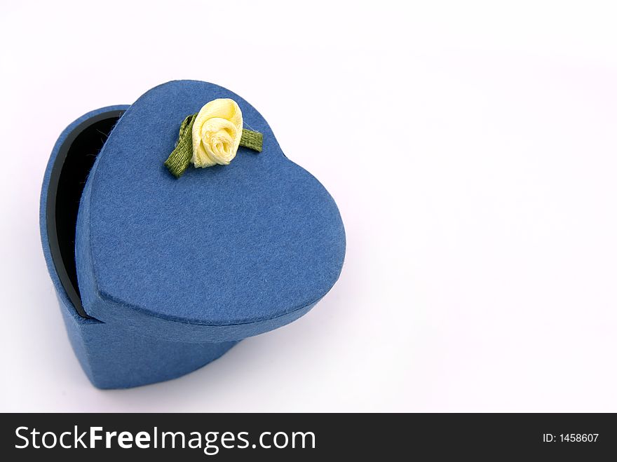 A blue heart shape gift box with yellow rose