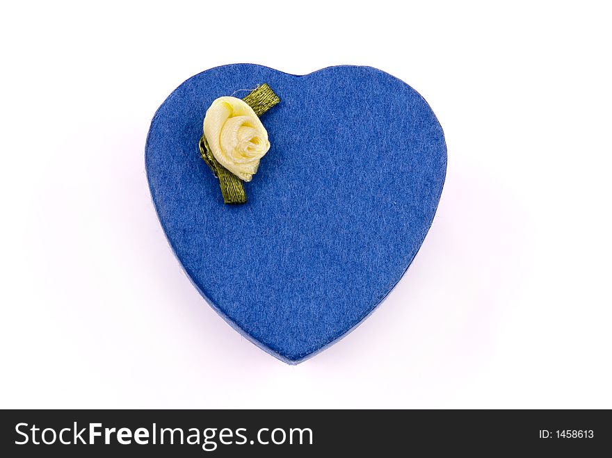 A blue heart shape gift box with yellow rose