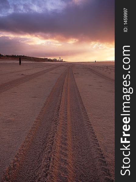 Tire tracks on the beach at night