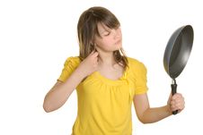Girl Looks In Reflexion At Bottom Of Frying Pan Royalty Free Stock Photos Girl Looks In Reflexion At Bottom Of Frying Pan Royalty Free Stock Photos