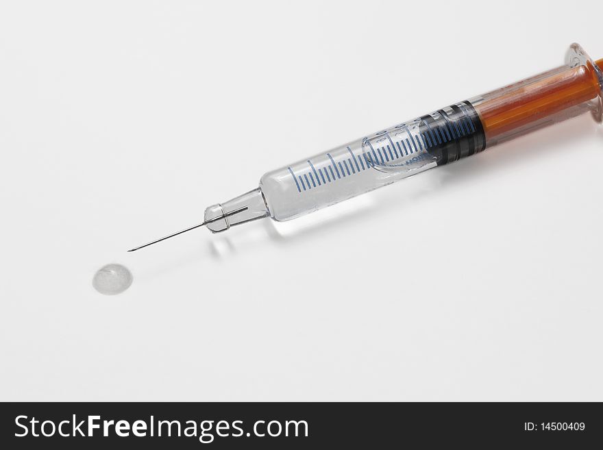 A syringe with the needle and the fluid prepared to medicate. A syringe with the needle and the fluid prepared to medicate