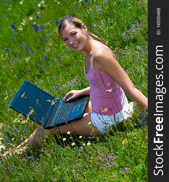 Beautiful young girls in nature using a computer. Beautiful young girls in nature using a computer.