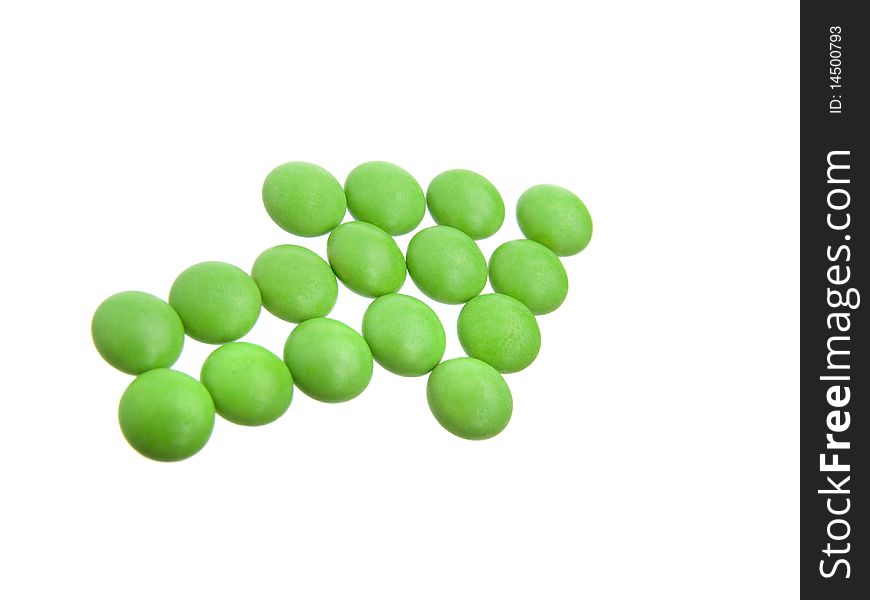 Green tablets in arrow formation, isolated on white background