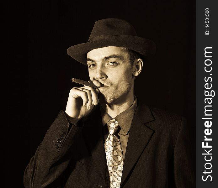 Old style photo of man in suit with cigar. Old style photo of man in suit with cigar