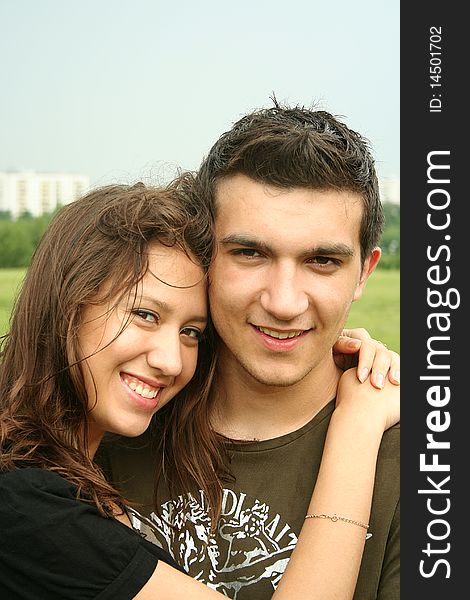 Young Man And Girl Embracing Outdoor