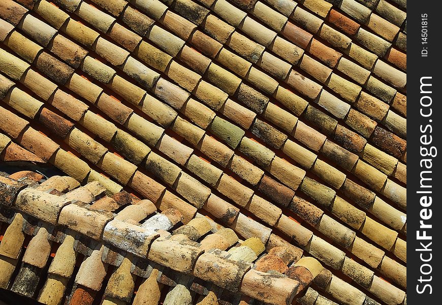 Roof covering of ceramic rustic tiles, aerial view, background. Roof covering of ceramic rustic tiles, aerial view, background