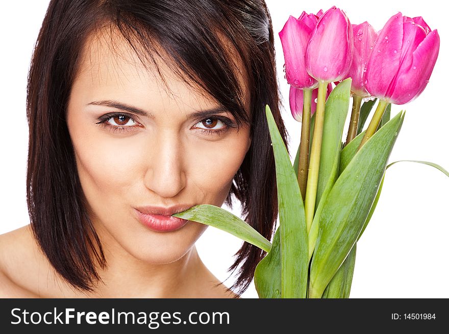 Beautiful young female with bunch of pink tulips, chewing a leaf, isolated. Beautiful young female with bunch of pink tulips, chewing a leaf, isolated