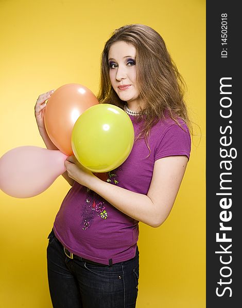 Young pretty girl with balloons in studio