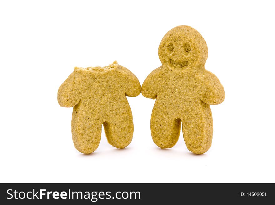 Two gingerbread men one with head bitten off