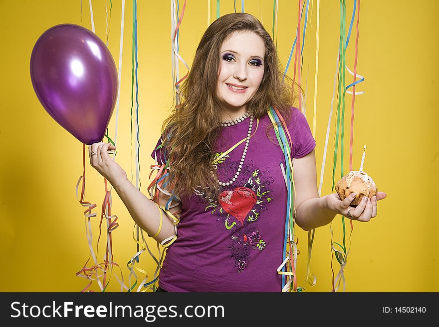 Pretty girl with balloon, cake and paper streamer in studio. Pretty girl with balloon, cake and paper streamer in studio