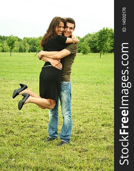 Young man and girl embracing outdoor