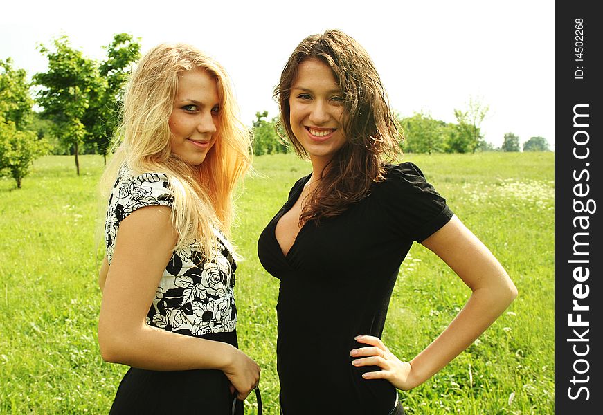 Two young beautiful girls outdoor summer time