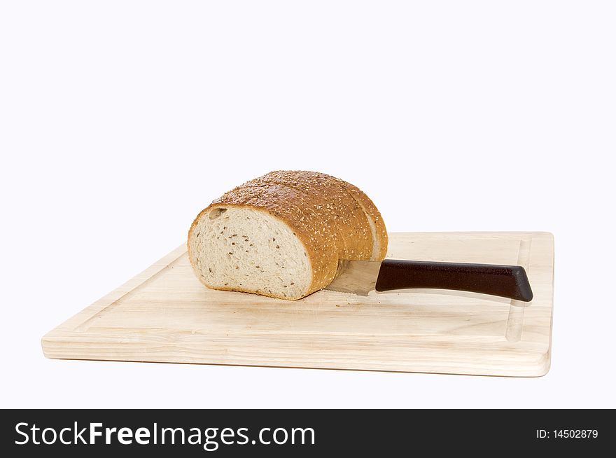 Bread cut by knife on a wooden kitchen board, isolated on white. Bread cut by knife on a wooden kitchen board, isolated on white