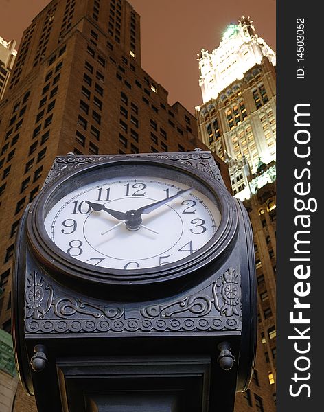 An old fashion clock in downtown Manhattan with skysrcrapers behind it. An old fashion clock in downtown Manhattan with skysrcrapers behind it.