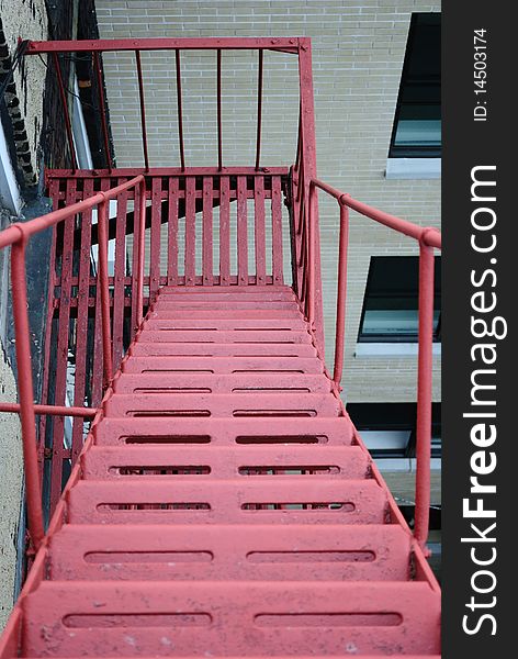 A red fire escape in an urban setting.