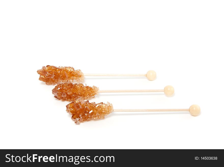 Three brown sugar sticks isolated over white