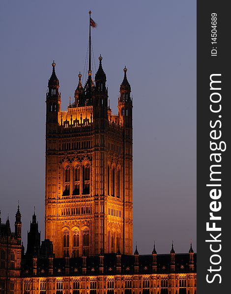 Flag On Illuminated Houses Of Parliament