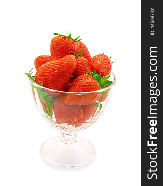 Fresh strawberries in a glass on a white background