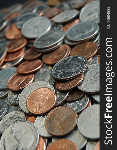 A whole bunch of American coins piled on top of one another to make this background. Shallow depth of field. A whole bunch of American coins piled on top of one another to make this background. Shallow depth of field.