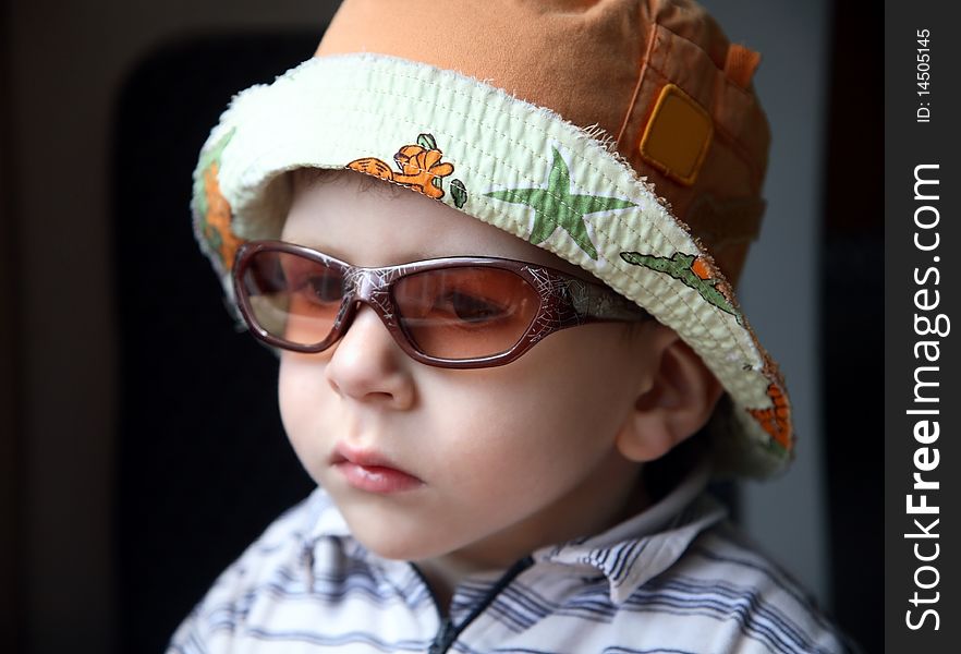 Little boy with sunglasses and hat