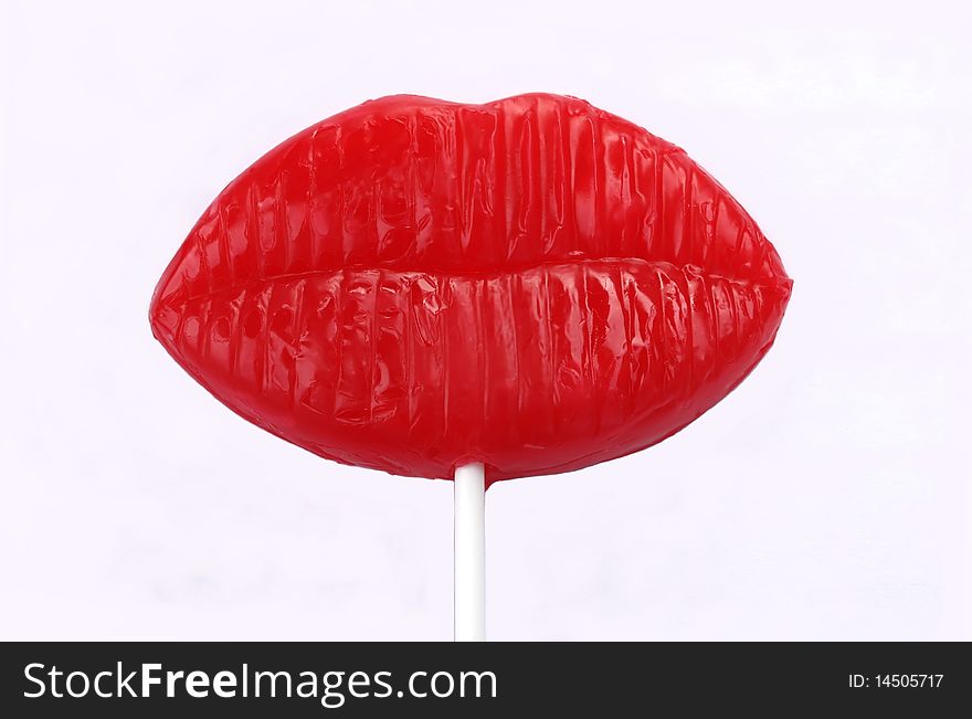 Red lips candy lollipop on white background