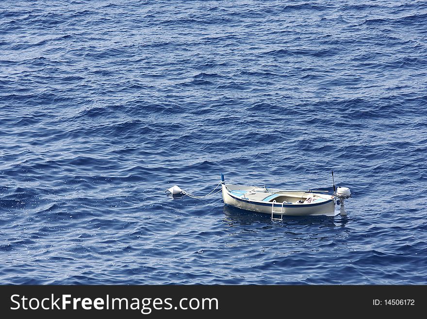 A small fishing boat at anchor in the mediterranean