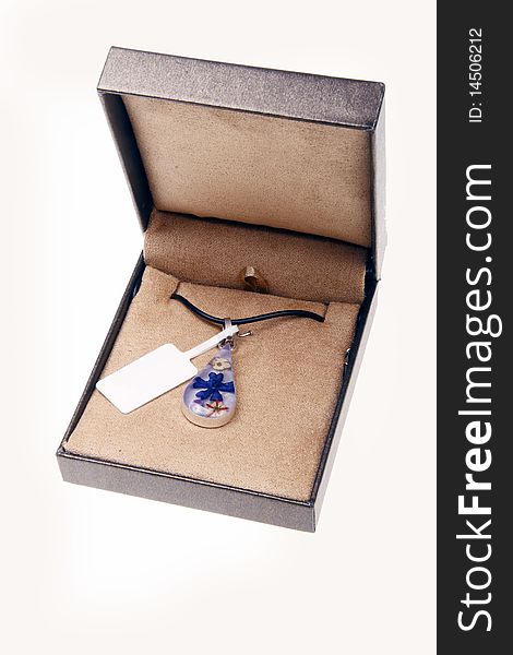 Glass pendant in a box.(on white)